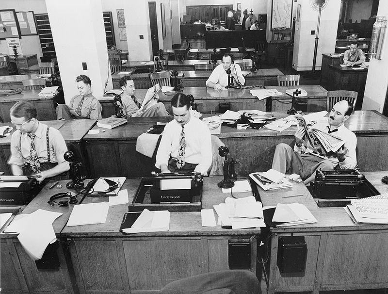 Male reporters at the New York Times office circa 1942. Has much changed since then? (Credit: Wikimedia Commons)