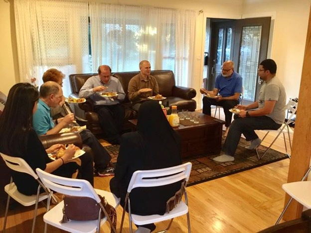 Yusra and her guests enjoying homemade food and open conversation. Photo Credit: Dine With a Muslim Family/ Facebook