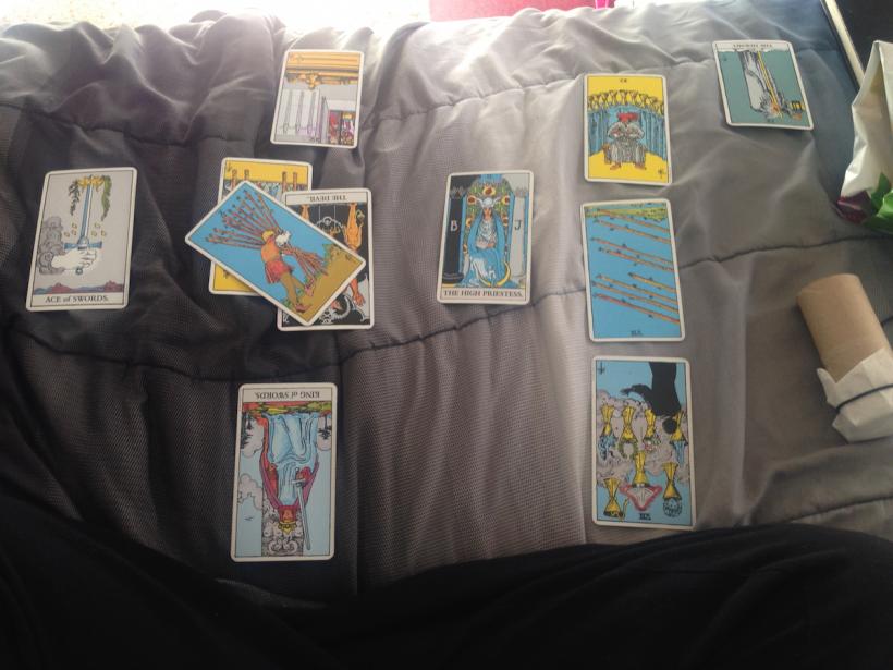 The Four of Swords reversed can be seen at the top of the spread.