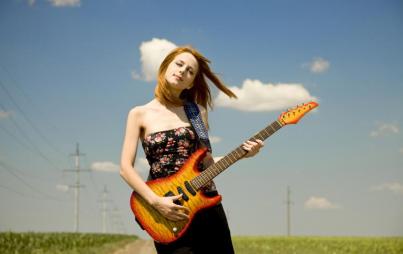 "When you’re wearing your belly-covering guitar, people will think you’re a real cool rock lady who spends the time when she’s not writing songs totally probably going to the gym." Image: Thinkstock