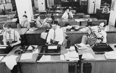 Male reporters at the New York Times office circa 1942. Has much changed since then? (Credit: Wikimedia Commons)