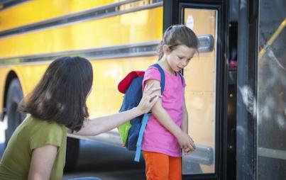 Don't be fooled. She's actually pushing that child onto the bus.